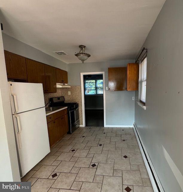 203 Robbins Street Philadelphia, PA 19111 - Photo 12 of 31 a kitchen with a refrigerator and a stove