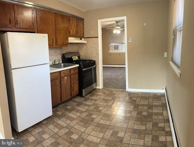 203 Robbins Street Philadelphia, PA 19111 - Photo 23 of 31 a kitchen with granite countertop a refrigerator and a stove top oven