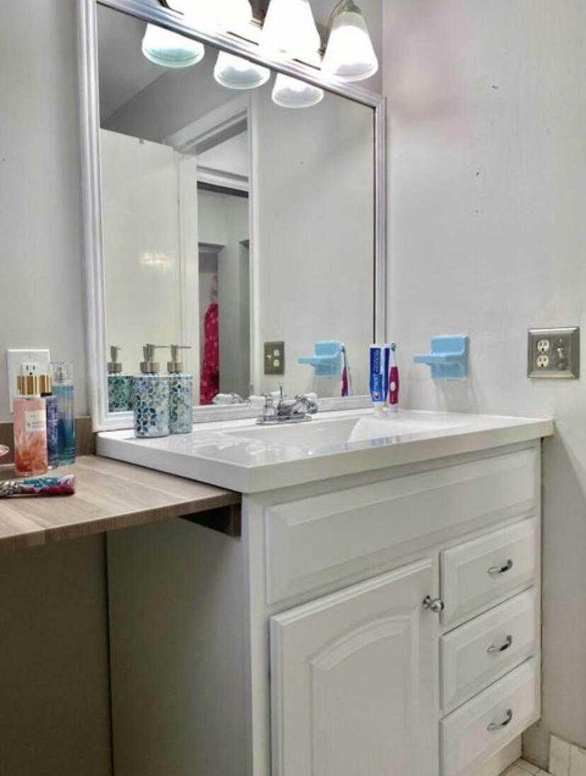 1100 Tallwood Avenue, Unit 201 Hollywood, FL 33021 - Photo 15 of 18 a bathroom with a sink and a mirror