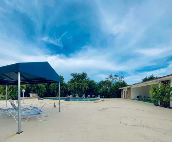 a view of a house with backyard and porch