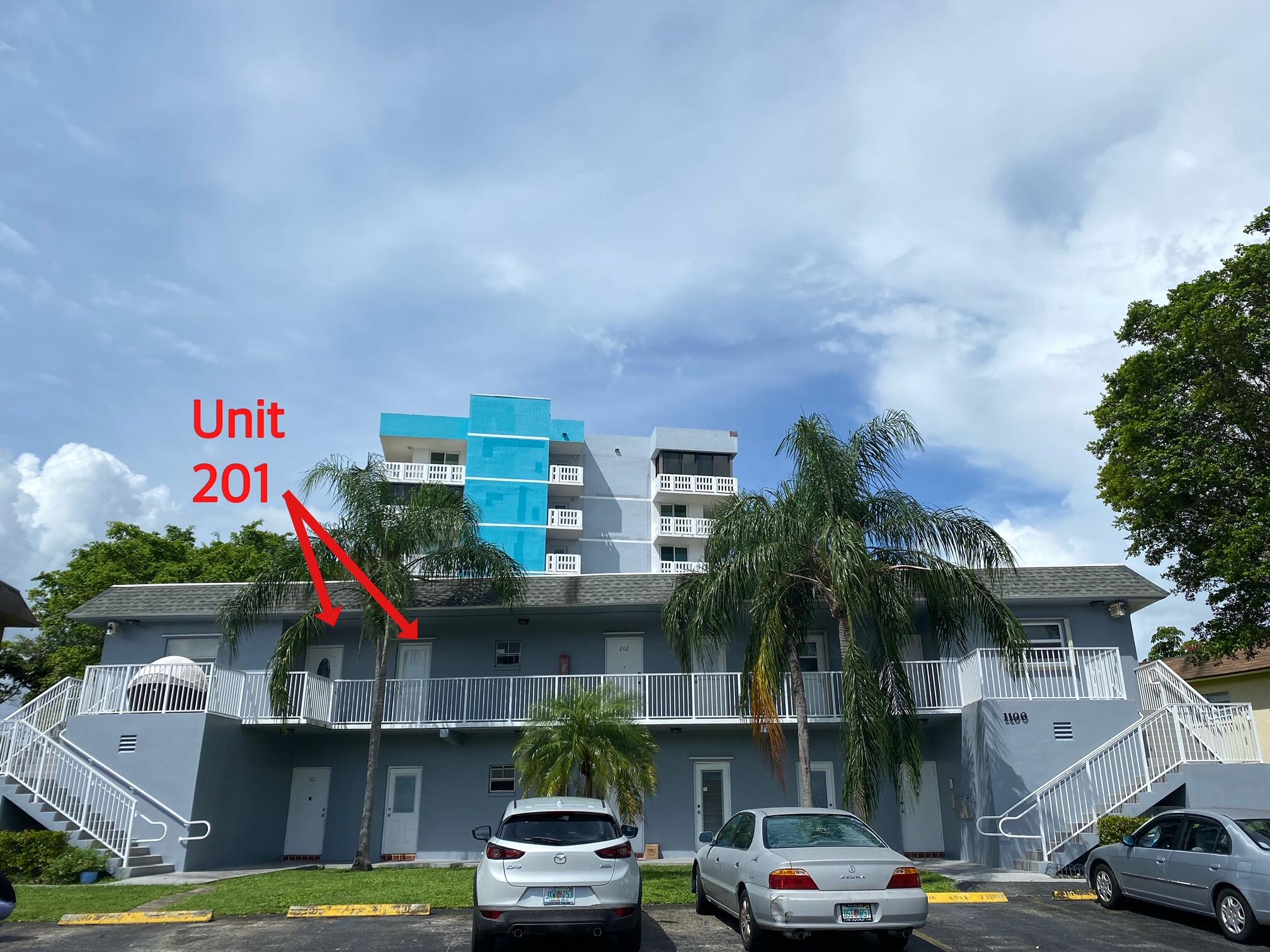 1100 Tallwood Avenue, Unit 201 Hollywood, FL 33021 - Photo 2 of 18 a front view of a building with cars parked