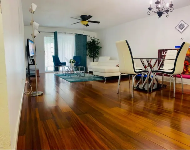 a living room with furniture and a wooden floor