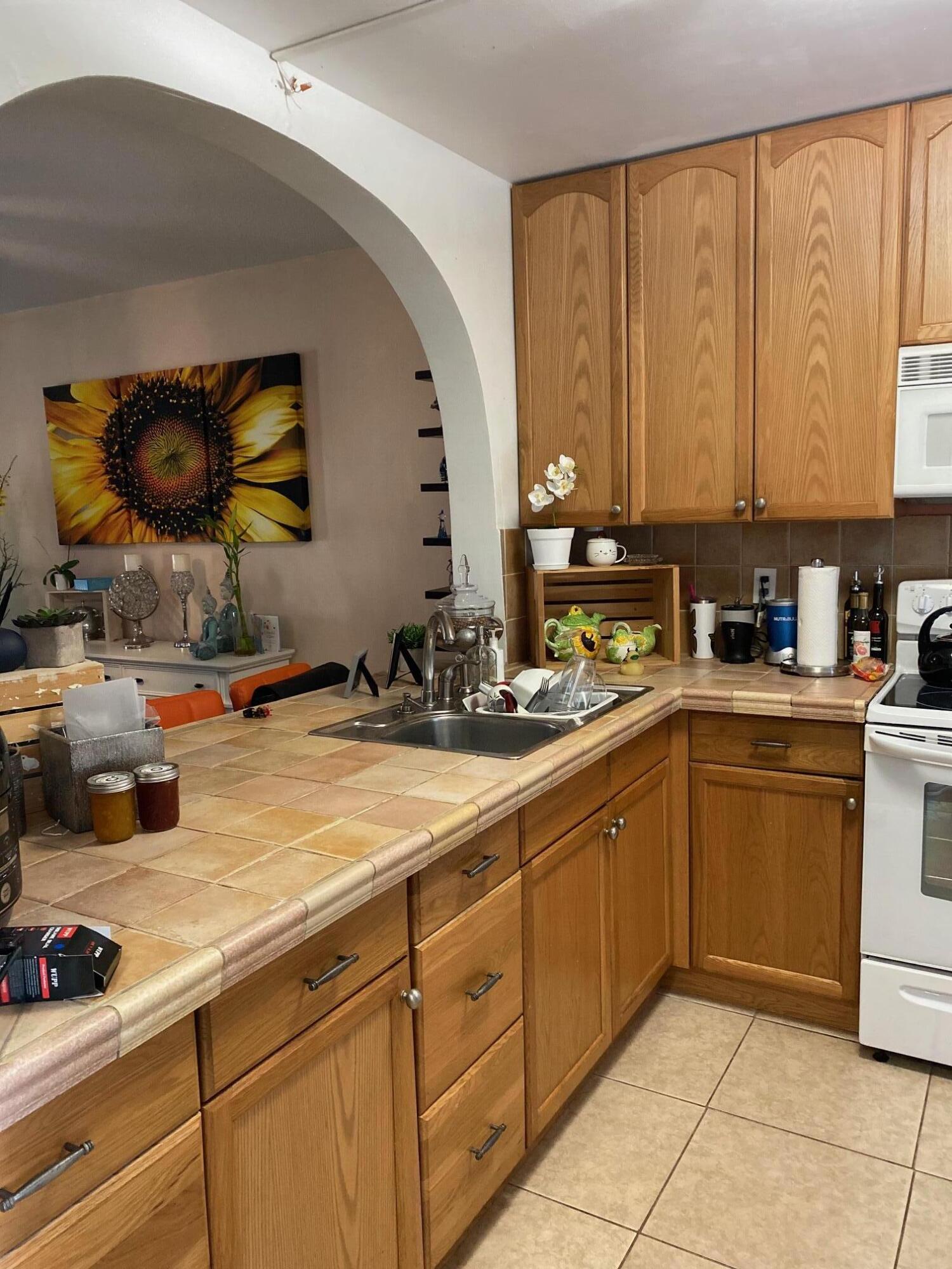 1100 Tallwood Avenue, Unit 201 Hollywood, FL 33021 - Photo 9 of 18 a kitchen with a sink and cabinets