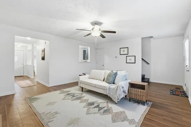 a living room with furniture and a chandelier