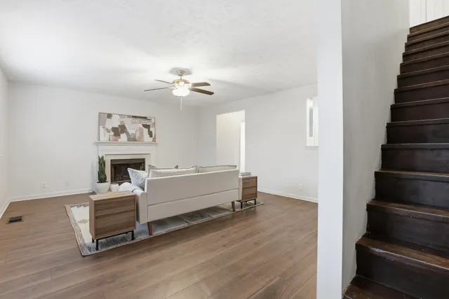 a view of a livingroom with furniture and staircase