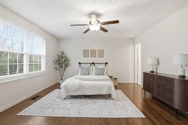 a bedroom with a large bed and a chandelier