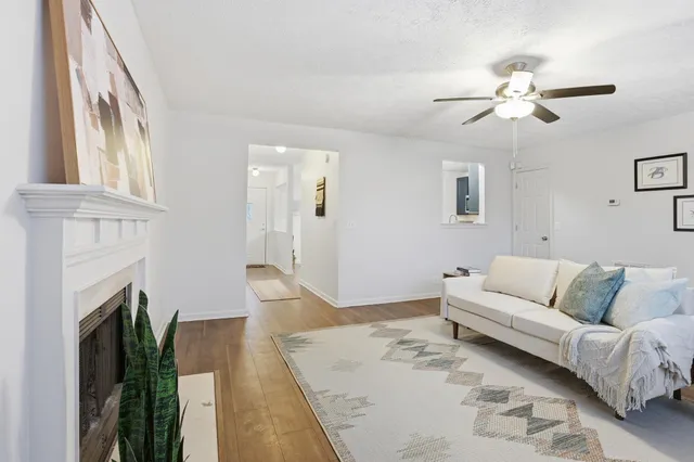 a living room with furniture and a fireplace