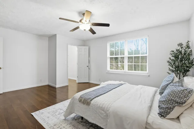 a bedroom with a large bed and a window
