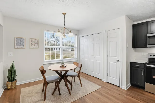 a view of a dining room with furniture window and wooden floor