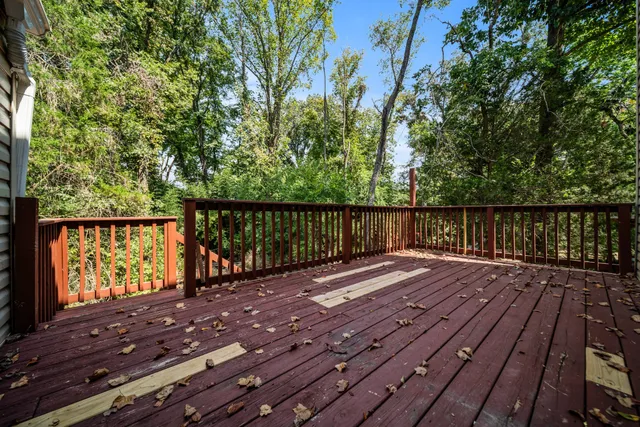 a view of deck with wooden floor and fence