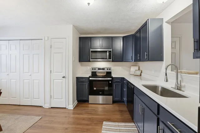 a kitchen with stainless steel appliances granite countertop a stove and a sink