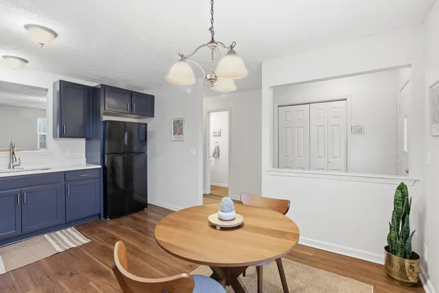 a kitchen with stainless steel appliances granite countertop a sink and a refrigerator