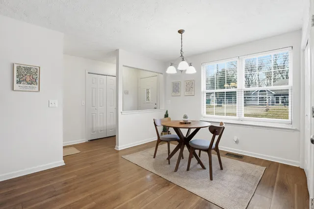 a view of a dining room with furniture window and wooden floor