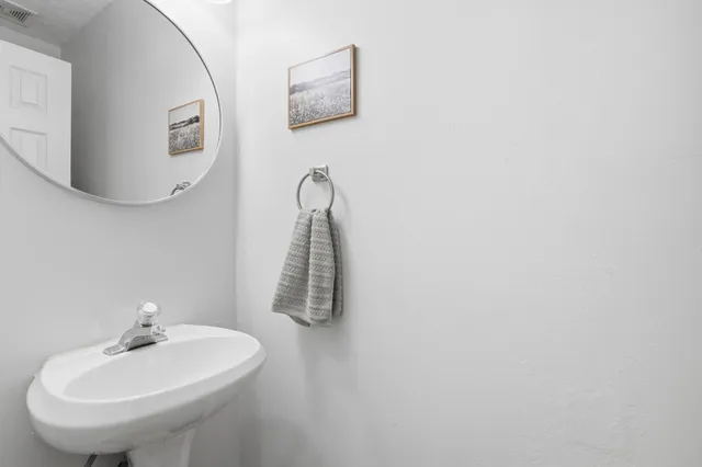 a bathroom with a sink and mirror