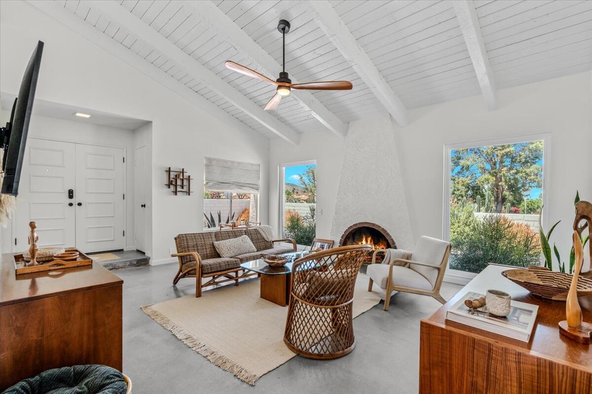 73149 Haystack Road Palm Desert, CA 92260 - Photo 11 of 32 a living room with furniture a window and gym equipment