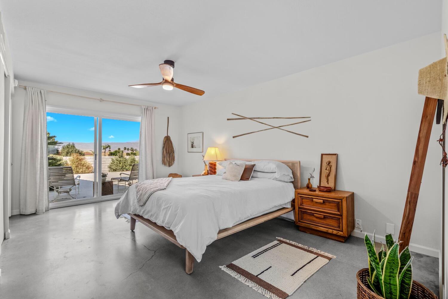 73149 Haystack Road Palm Desert, CA 92260 - Photo 17 of 32 a bedroom with a bed and wooden floor