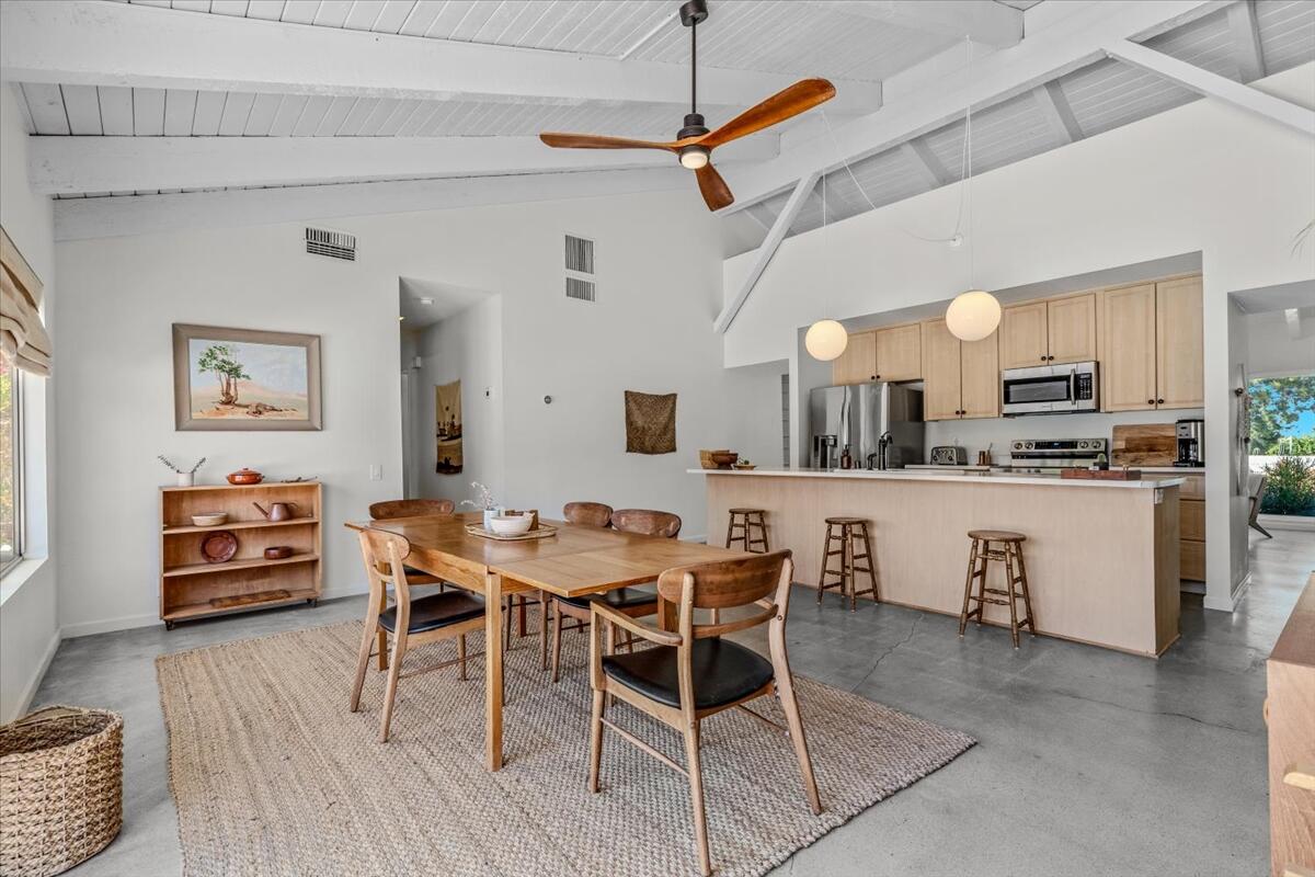 73149 Haystack Road Palm Desert, CA 92260 - Photo 20 of 32 a view of a dining room with furniture and wooden floor
