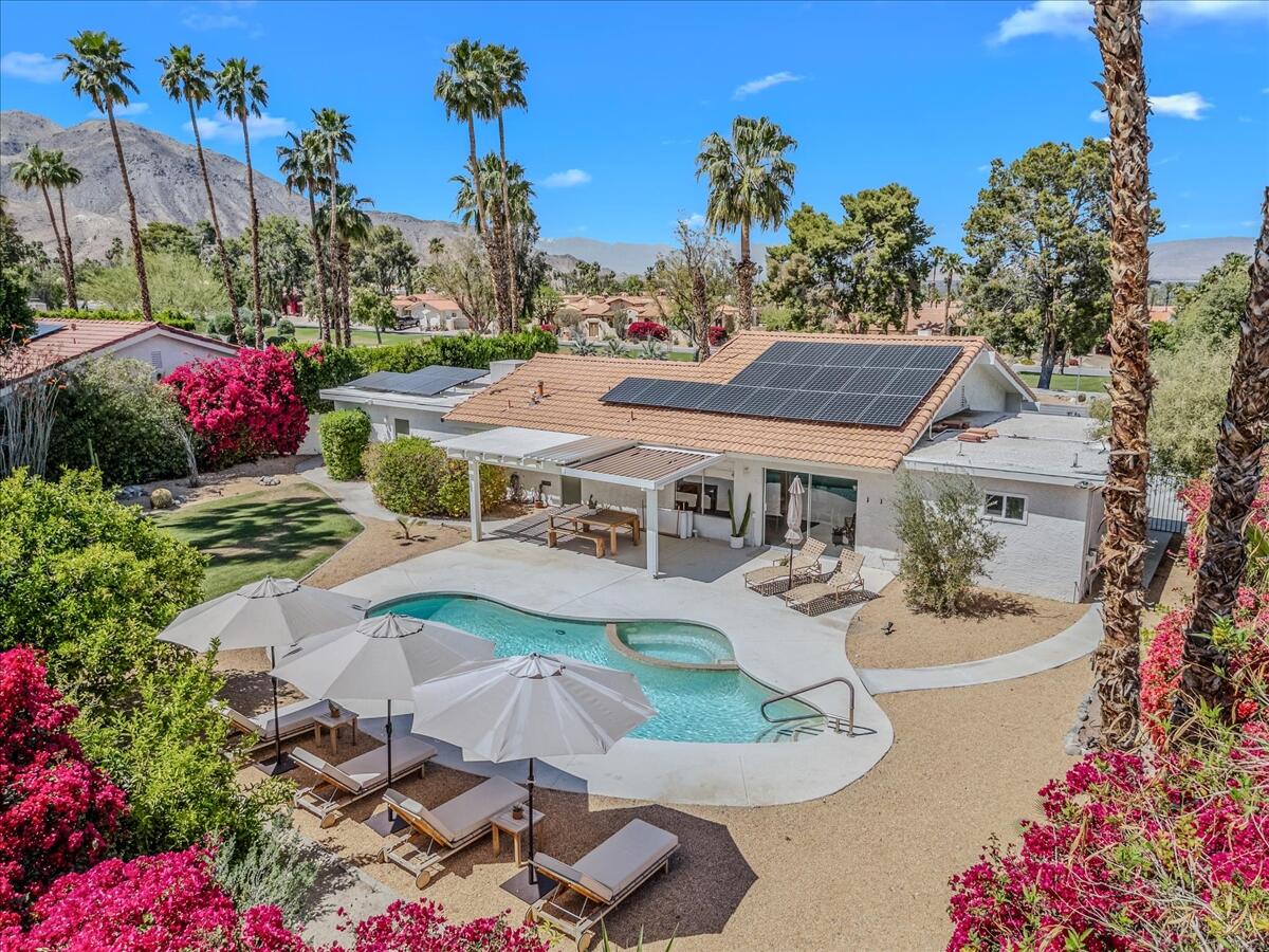 73149 Haystack Road Palm Desert, CA 92260 - Photo 5 of 32 a front view of a house with a yard and fountain