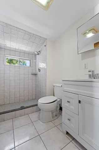 a bathroom with a toilet a sink and shower