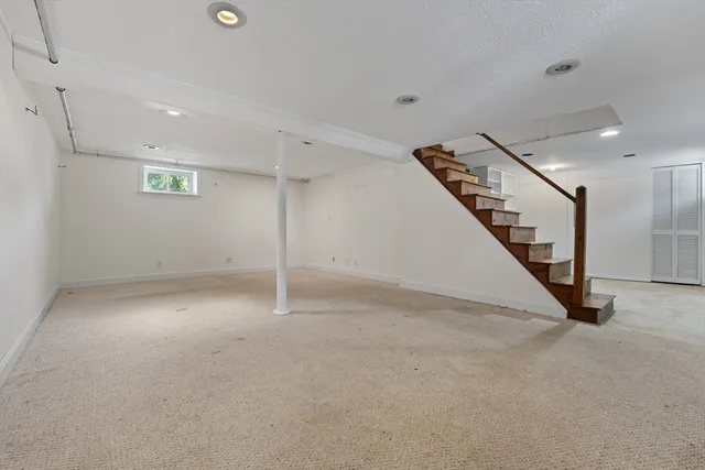 an empty room with stairs and white walls