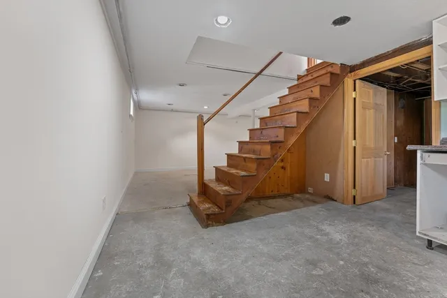 a view of an empty room with stairs