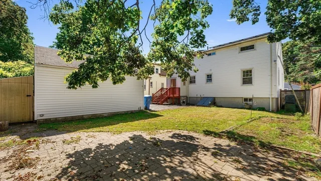 a view of a backyard with a tree
