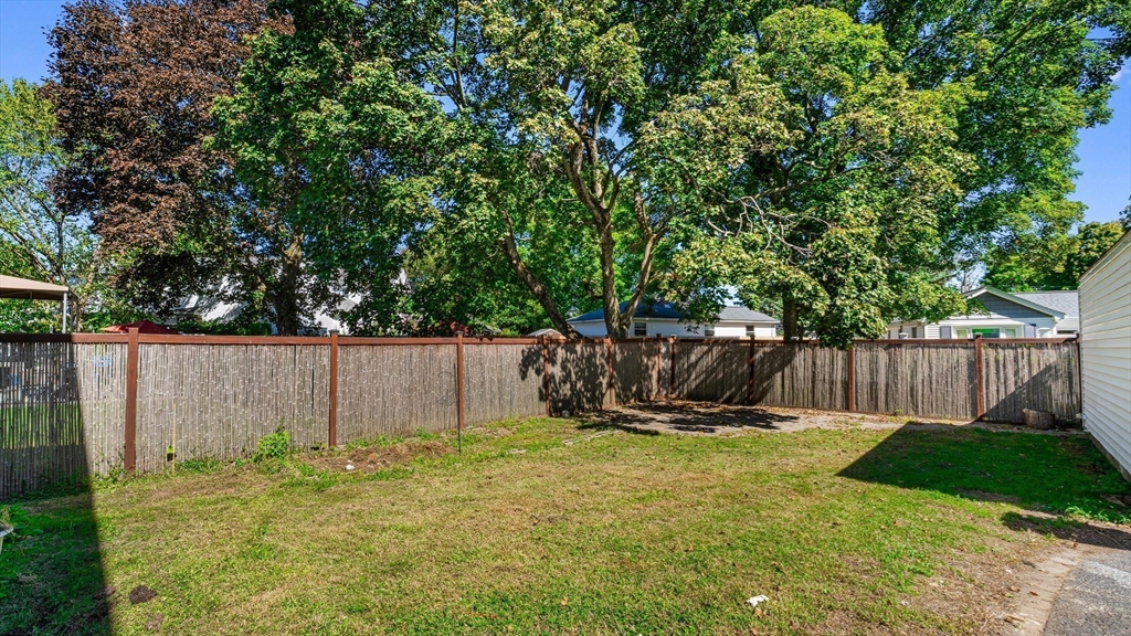 463 Lincoln Street Waltham, MA 02451 - Photo 17 of 23 a view of a backyard with a wooden fence