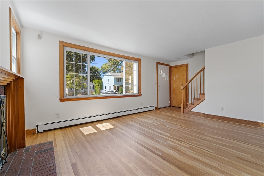 463 Lincoln Street Waltham, MA 02451 - Photo 2 of 23 an empty room with wooden floor and windows