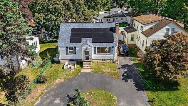 an aerial view of a house with a yard swimming pool and a yard