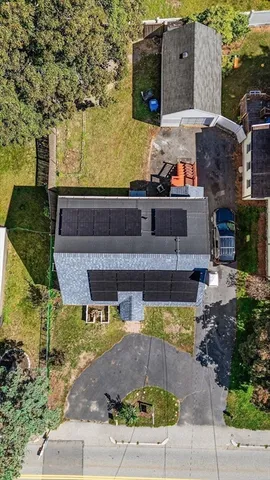 an aerial view of a house with a yard