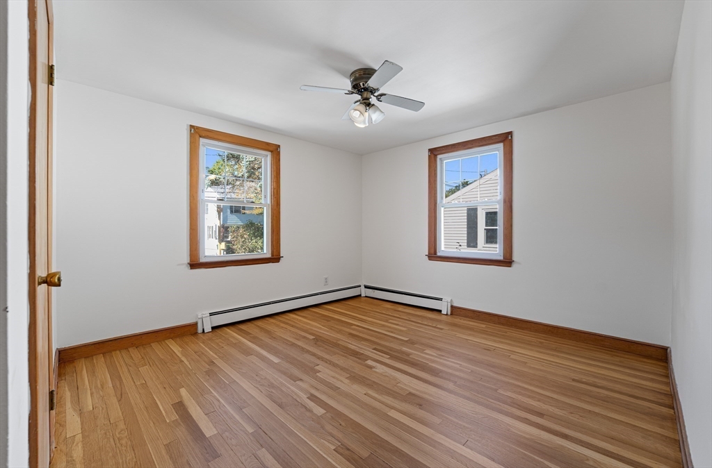 463 Lincoln Street Waltham, MA 02451 - Photo 5 of 23 a view of an empty room with wooden floor and a window