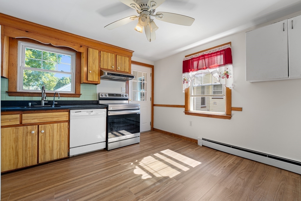 463 Lincoln Street Waltham, MA 02451 - Photo 8 of 23 a kitchen with stainless steel appliances granite countertop a stove a sink and a microwave