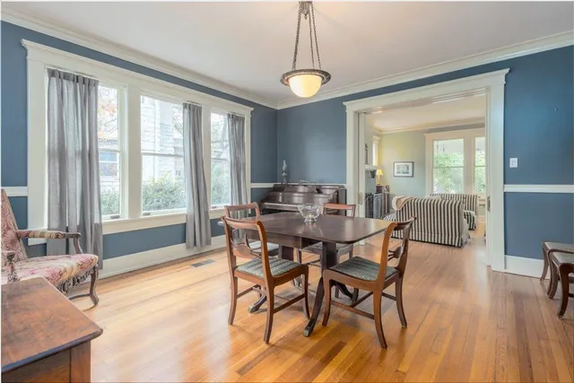 a view of a dining room with furniture window and wooden floor