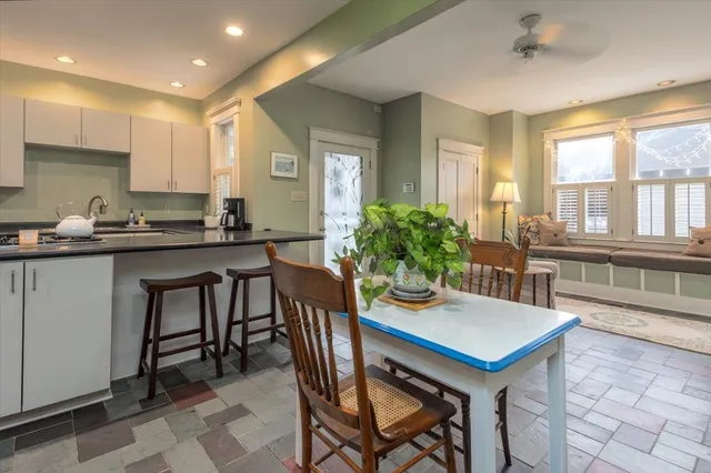 a kitchen with a table chairs stove and cabinets