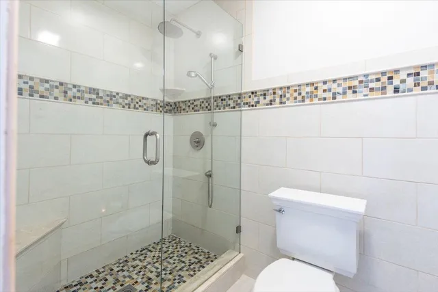 a bathroom with a toilet a shower and a sink