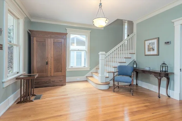 a view of a livingroom with wooden floor and furniture