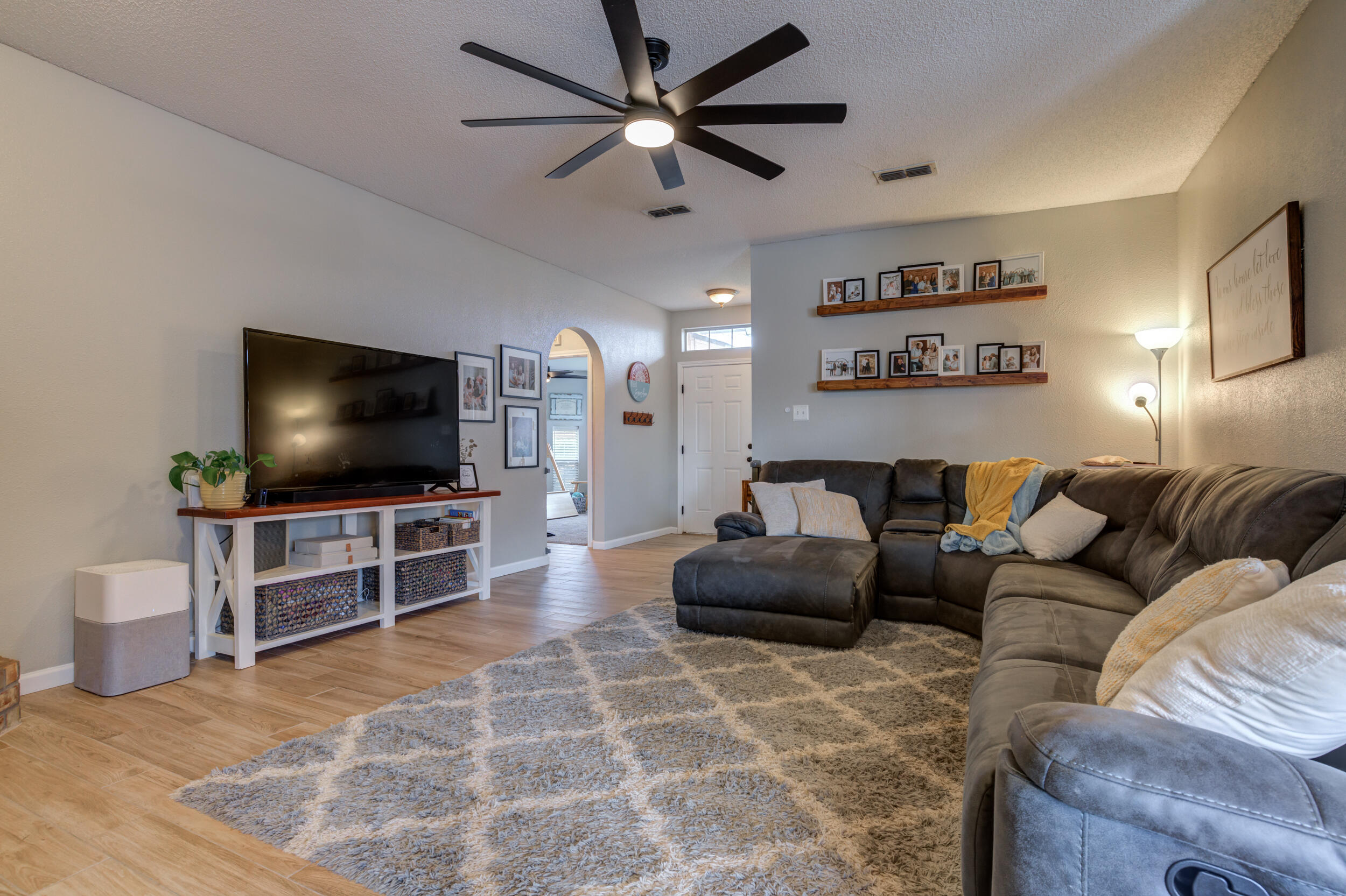 1607 79th Street Lubbock, TX 79423 - Photo 11 of 53 a living room with furniture and a flat screen tv