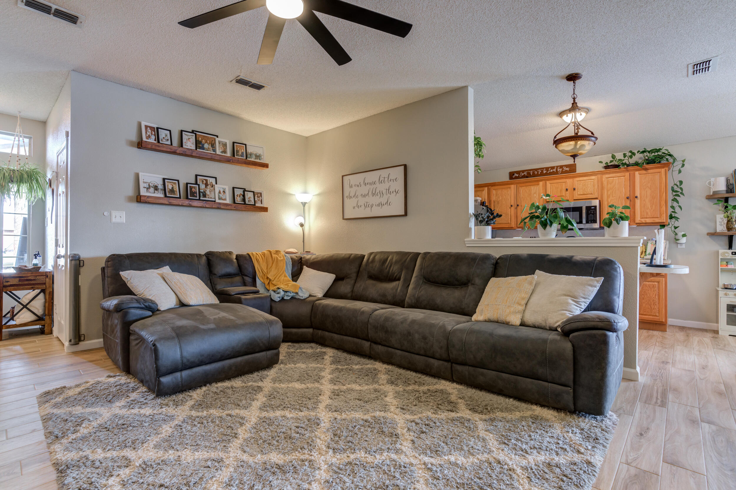 1607 79th Street Lubbock, TX 79423 - Photo 13 of 53 a living room with furniture and a chandelier
