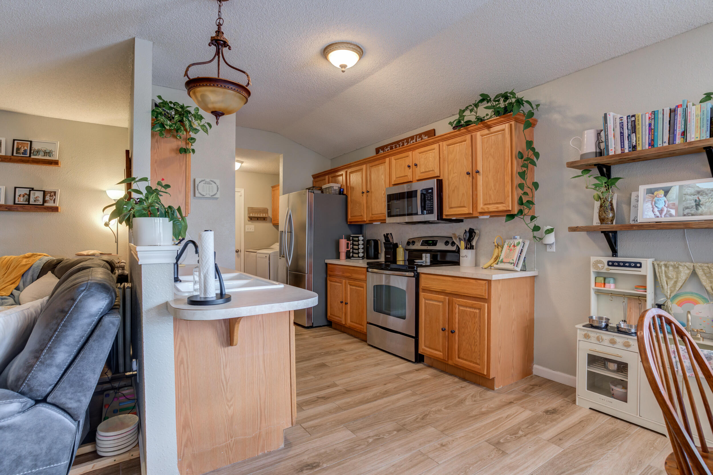 1607 79th Street Lubbock, TX 79423 - Photo 16 of 53 a kitchen with granite countertop a sink appliances cabinets and furniture