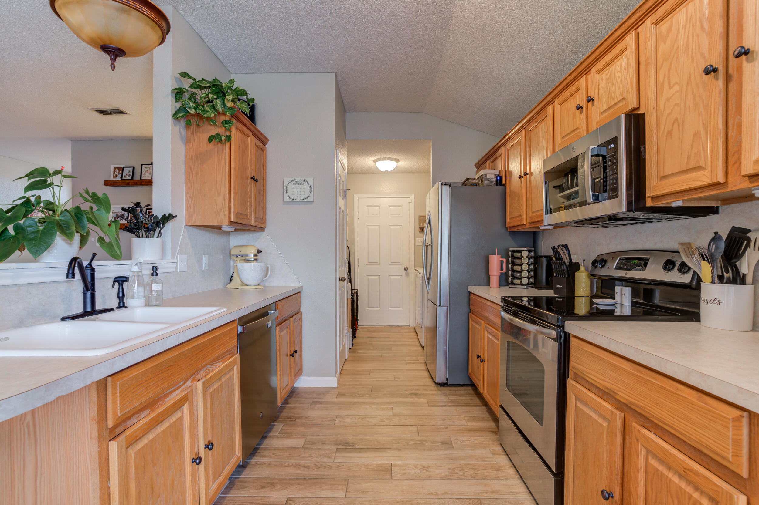 1607 79th Street Lubbock, TX 79423 - Photo 18 of 53 a kitchen with stainless steel appliances granite countertop a sink a stove cabinets and a kitchen island