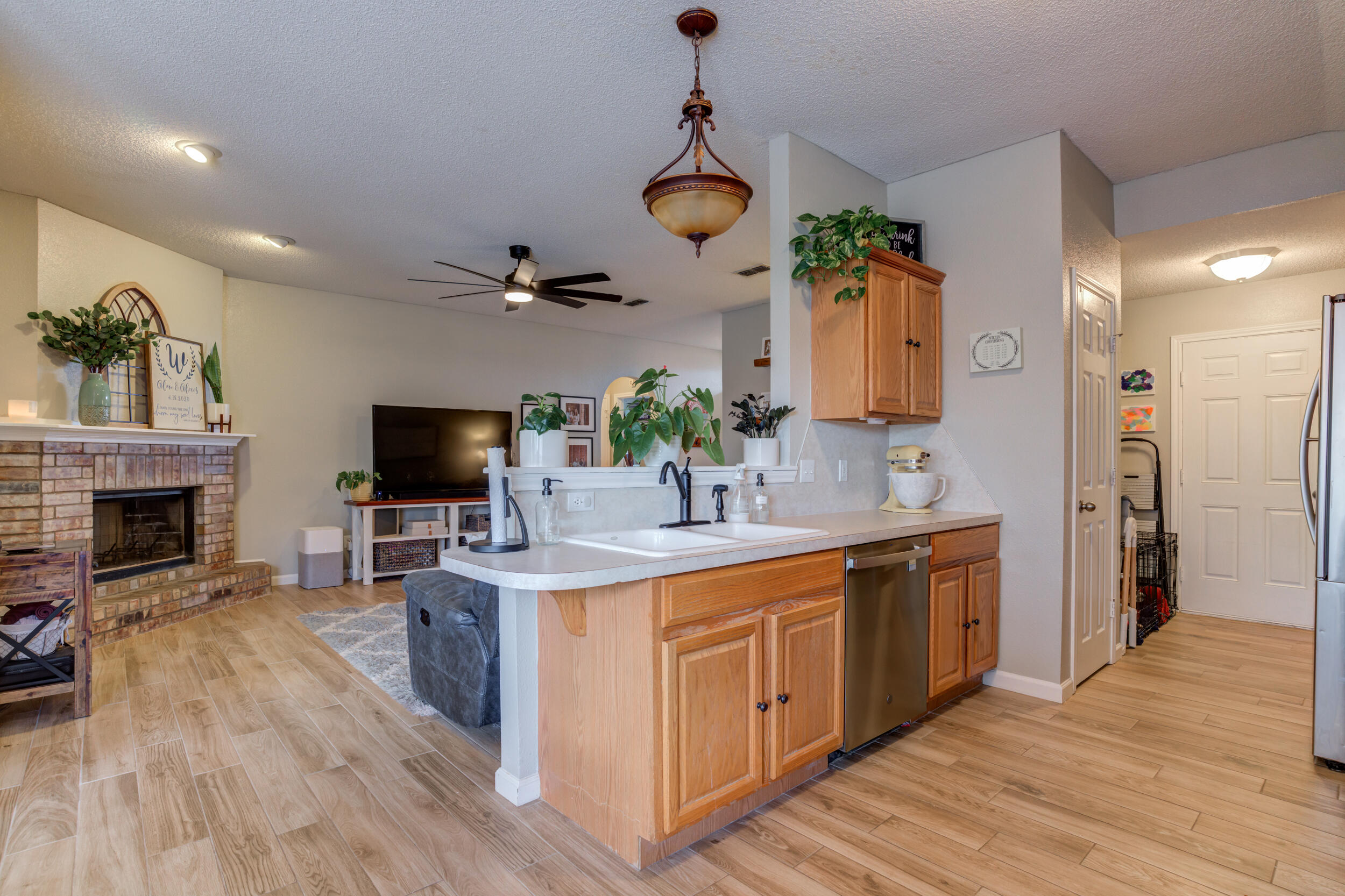 1607 79th Street Lubbock, TX 79423 - Photo 19 of 53 a view of living room with kitchen island furniture and fireplace