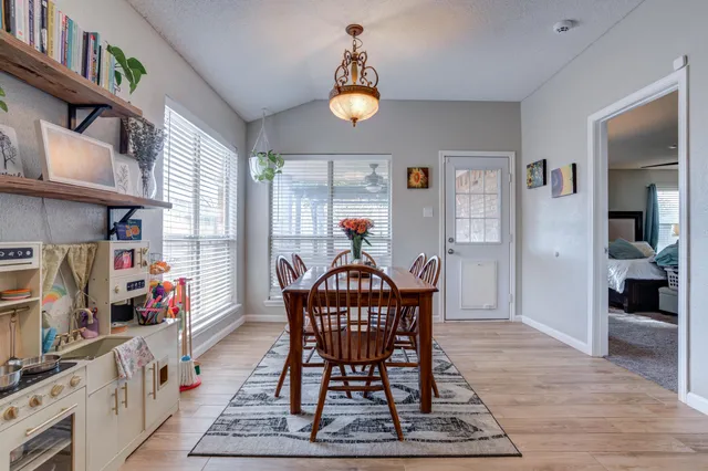 a living room with furniture a rug and a chandelier