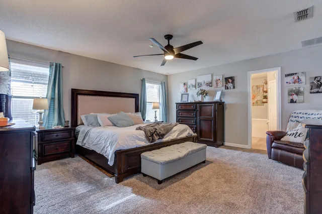 a bedroom with a bed couch and a window