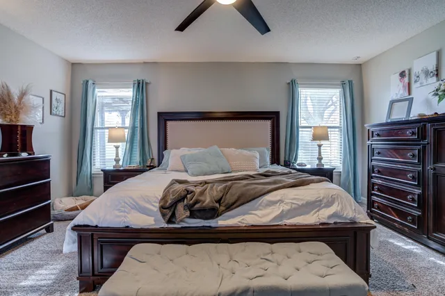 a bedroom with a bed window and a table