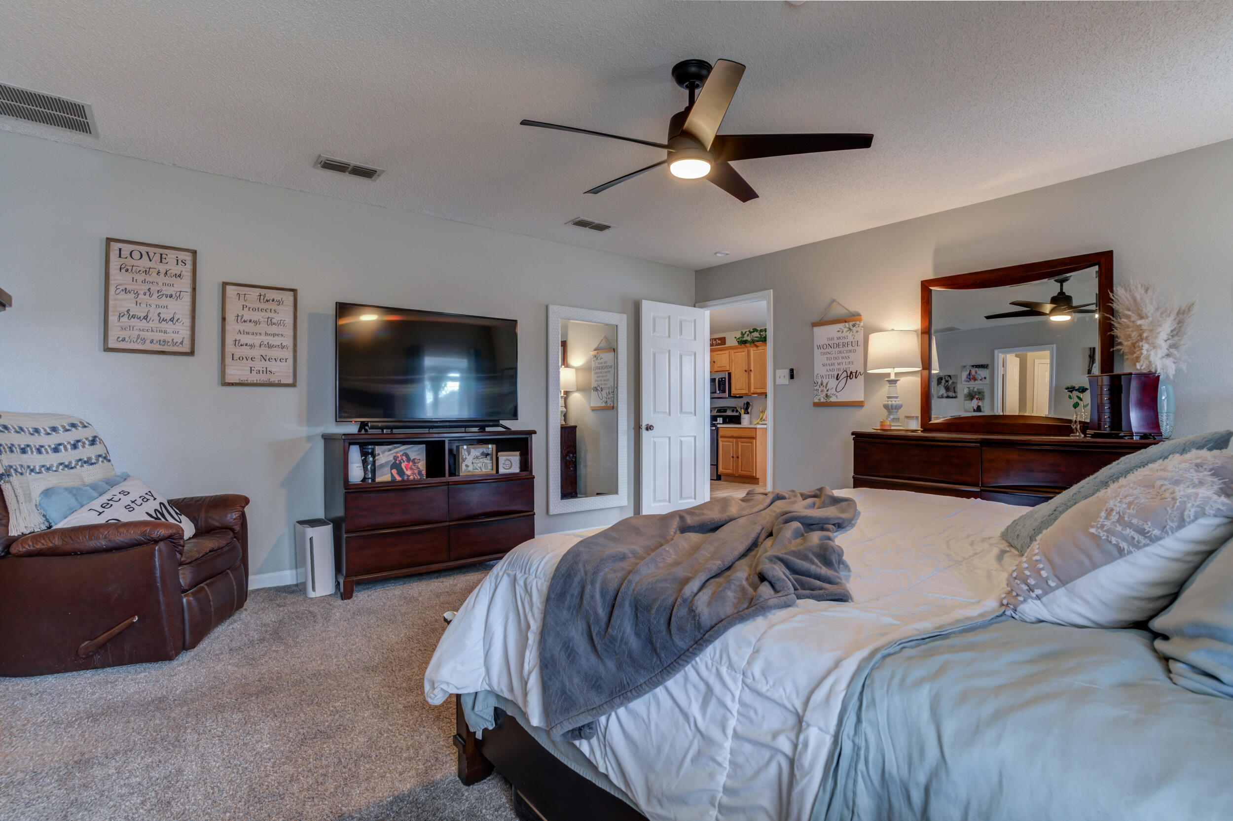 1607 79th Street Lubbock, TX 79423 - Photo 32 of 53 a bedroom with a bed and a flat screen tv