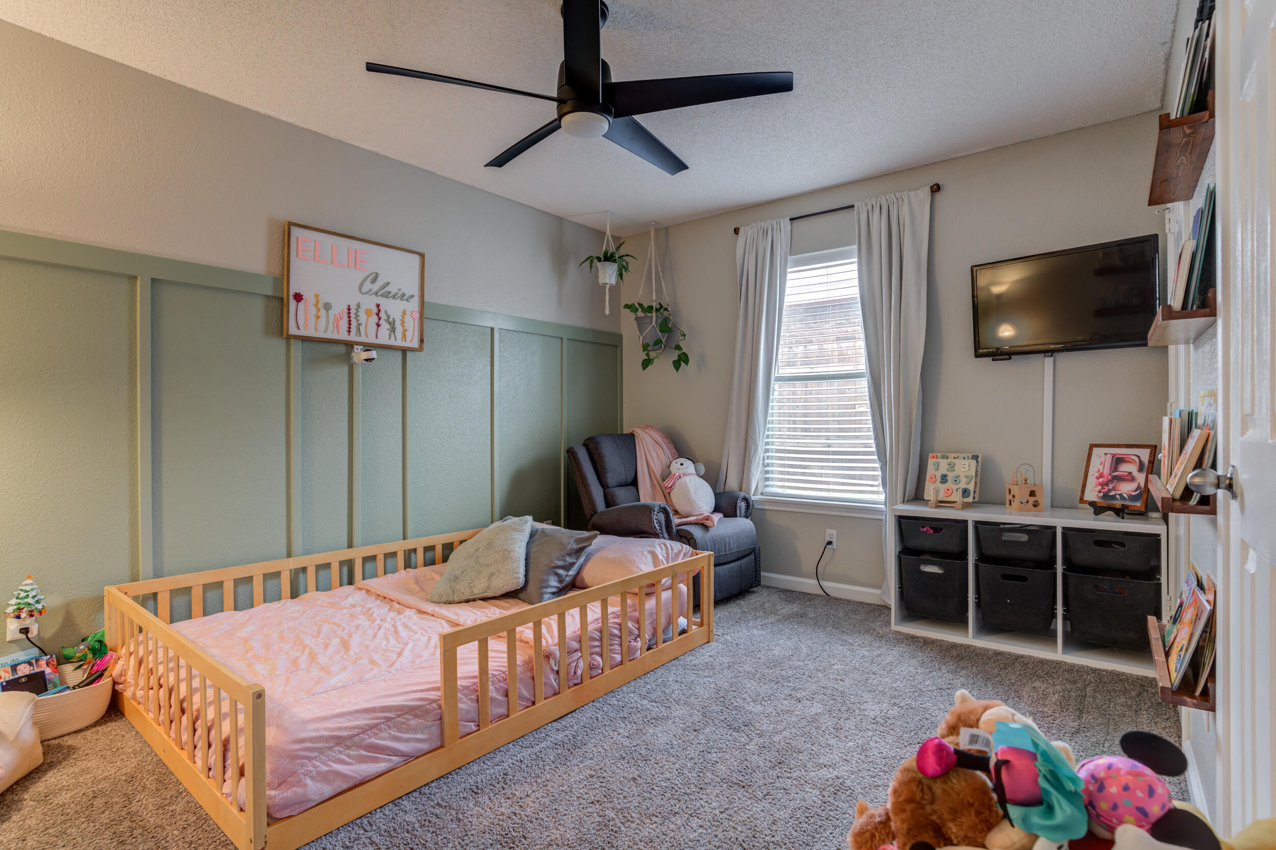 1607 79th Street Lubbock, TX 79423 - Photo 40 of 53 a bedroom with a bed and flat screen tv