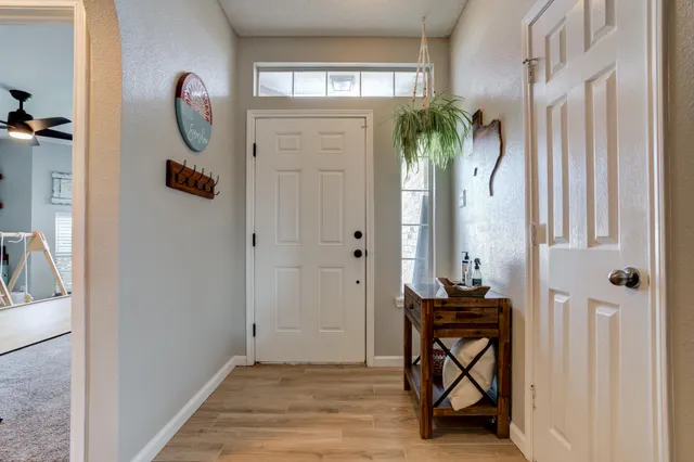 a view of entryway with wooden floor and mirror