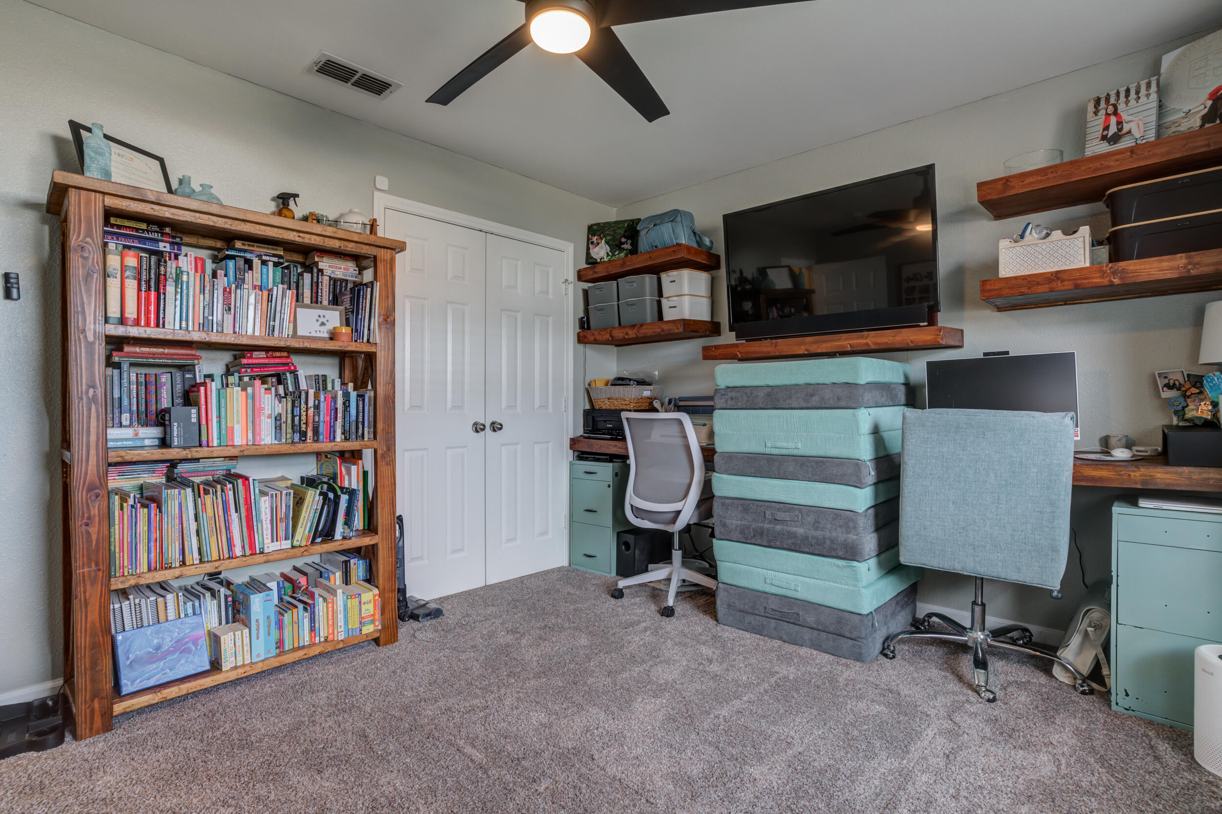 1607 79th Street Lubbock, TX 79423 - Photo 45 of 53 a view of a workspace with furniture and a bookshelf