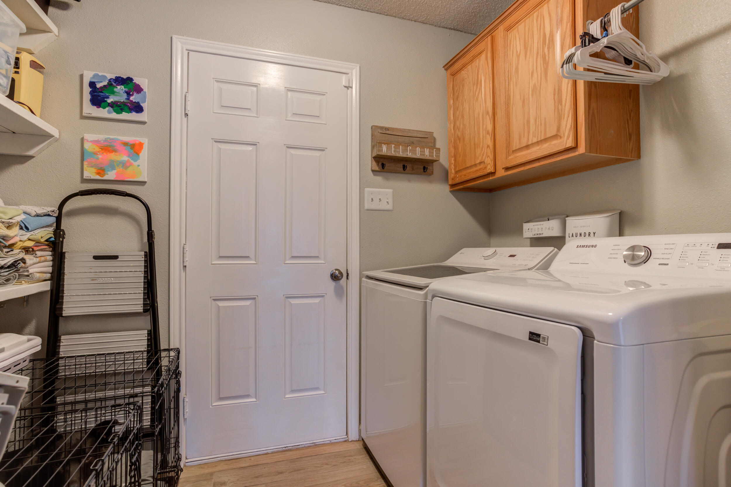 1607 79th Street Lubbock, TX 79423 - Photo 46 of 53 a utility room with cabinets washer and dryer