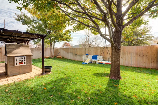 a view of a house with backyard porch and sitting area